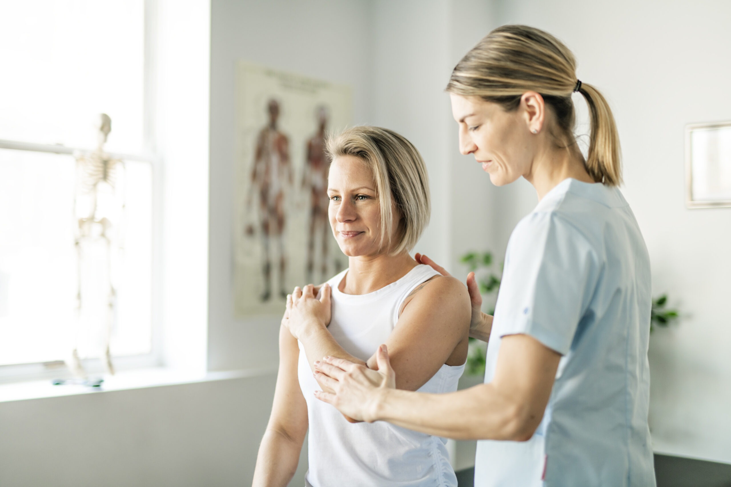 Modern rehabilitation physiotherapy worker with woman client