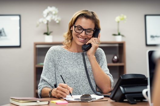 lady on phone at work - Home Physio Group